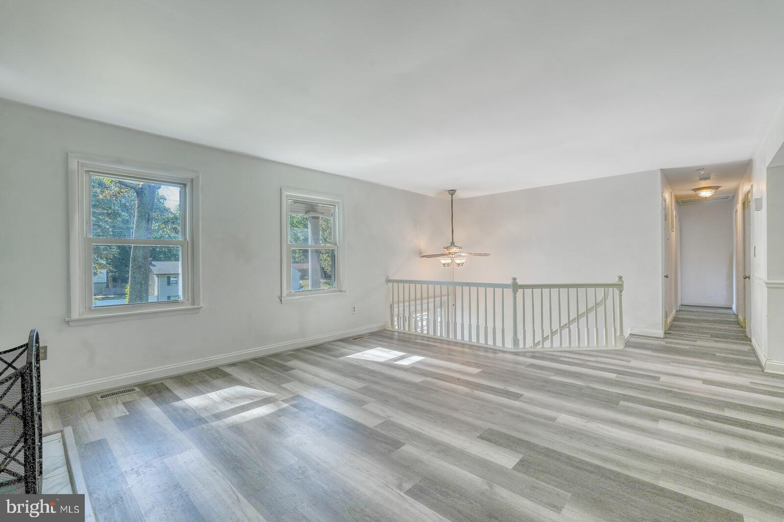 1142 Calvert Beach Road St. Leonard, MD 20685 - Photo 12 of 63 a view of an empty room with wooden floor and a window