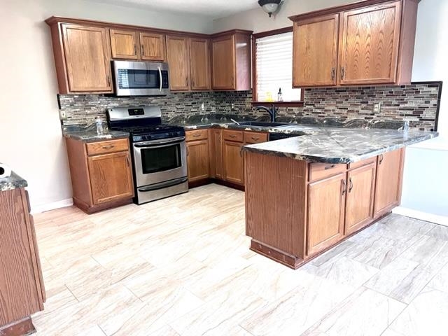 8375 Phillipson Way Memphis, TN 38125 - Photo 3 of 12 a kitchen with stainless steel appliances granite countertop a stove top oven a sink dishwasher and a microwave oven with white cabinets