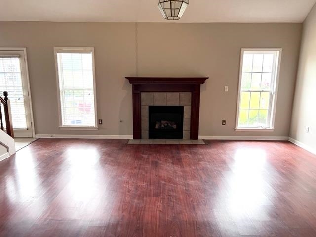 8375 Phillipson Way Memphis, TN 38125 - Photo 4 of 12 an empty room with wooden floor fireplace and windows