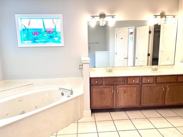 8375 Phillipson Way Memphis, TN 38125 - Photo 9 of 12 a spacious bathroom with a granite countertop sink a mirror a bathtub and vanity