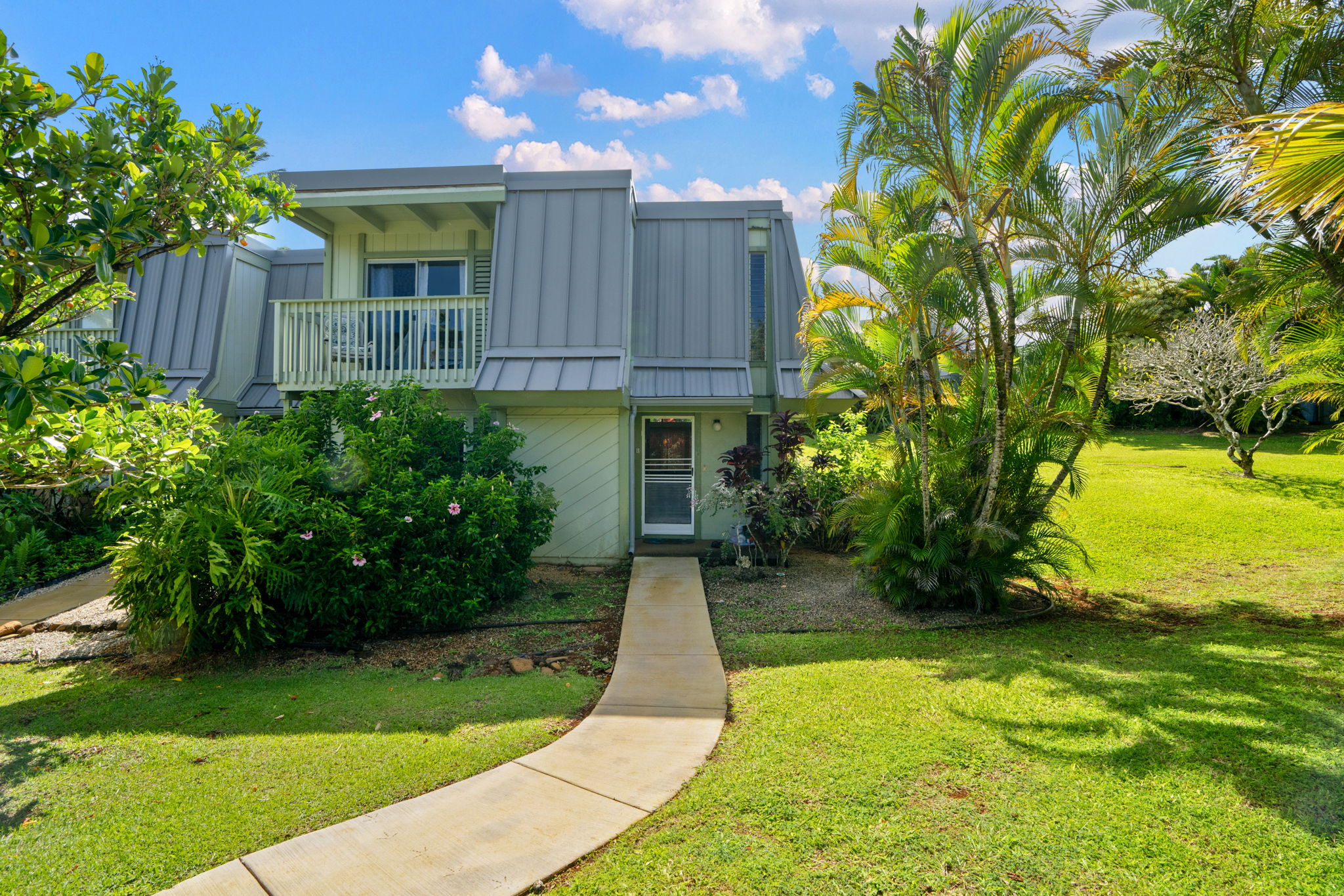 3880 Wyllie Road, Unit 20A Princeville, HI 96722 - Photo 1 of 28 a view of a backyard with plants and large trees