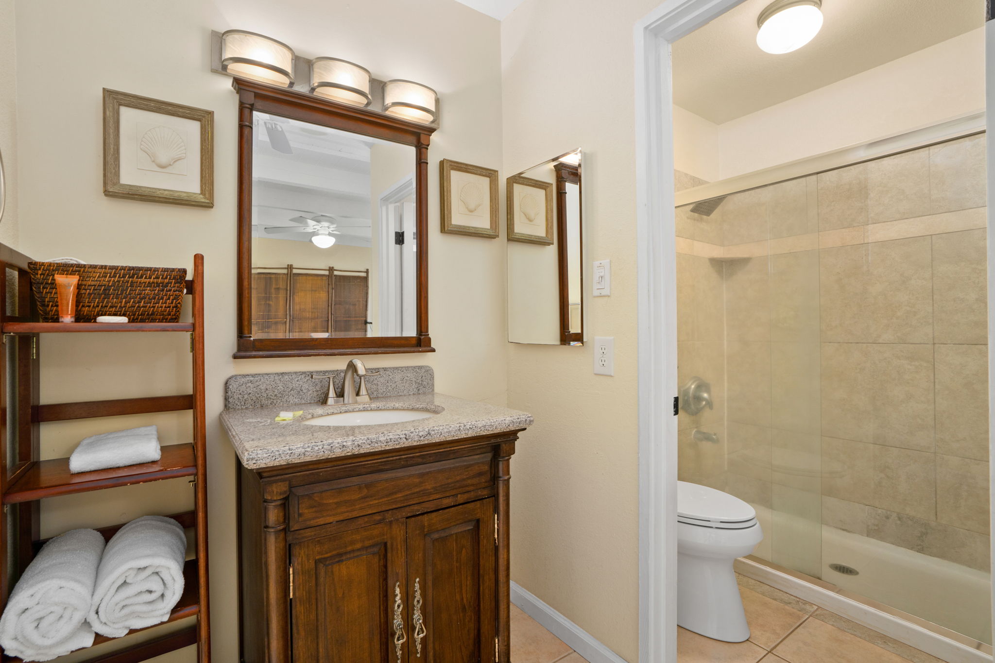 3880 Wyllie Road, Unit 20A Princeville, HI 96722 - Photo 16 of 28 a bathroom with a granite countertop sink toilet and shower