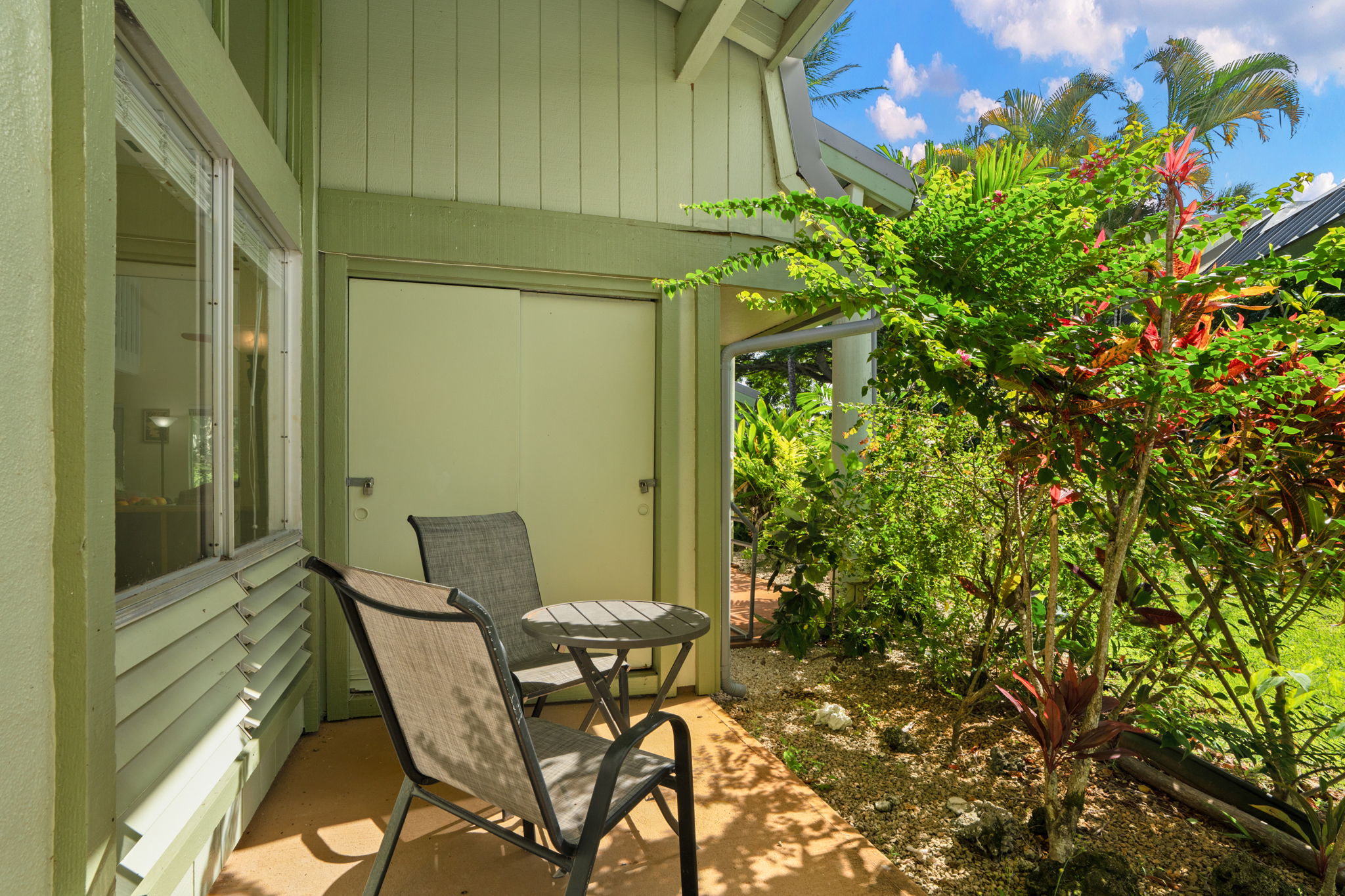 3880 Wyllie Road, Unit 20A Princeville, HI 96722 - Photo 17 of 28 a view of a backyard with chair and table