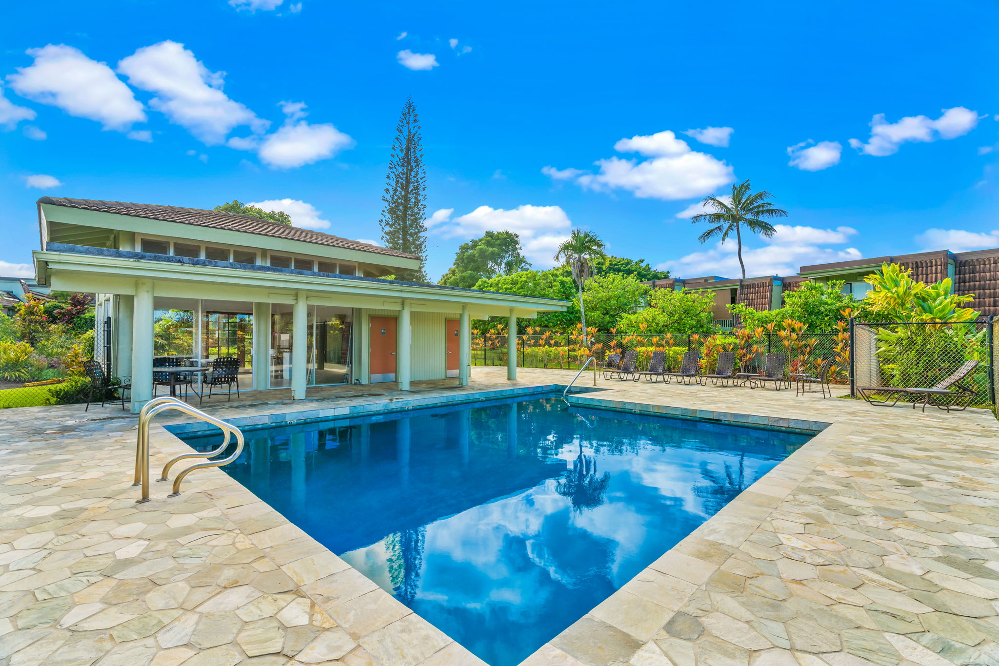 3880 Wyllie Road, Unit 20A Princeville, HI 96722 - Photo 18 of 28 a view of a house with swimming pool and sitting area