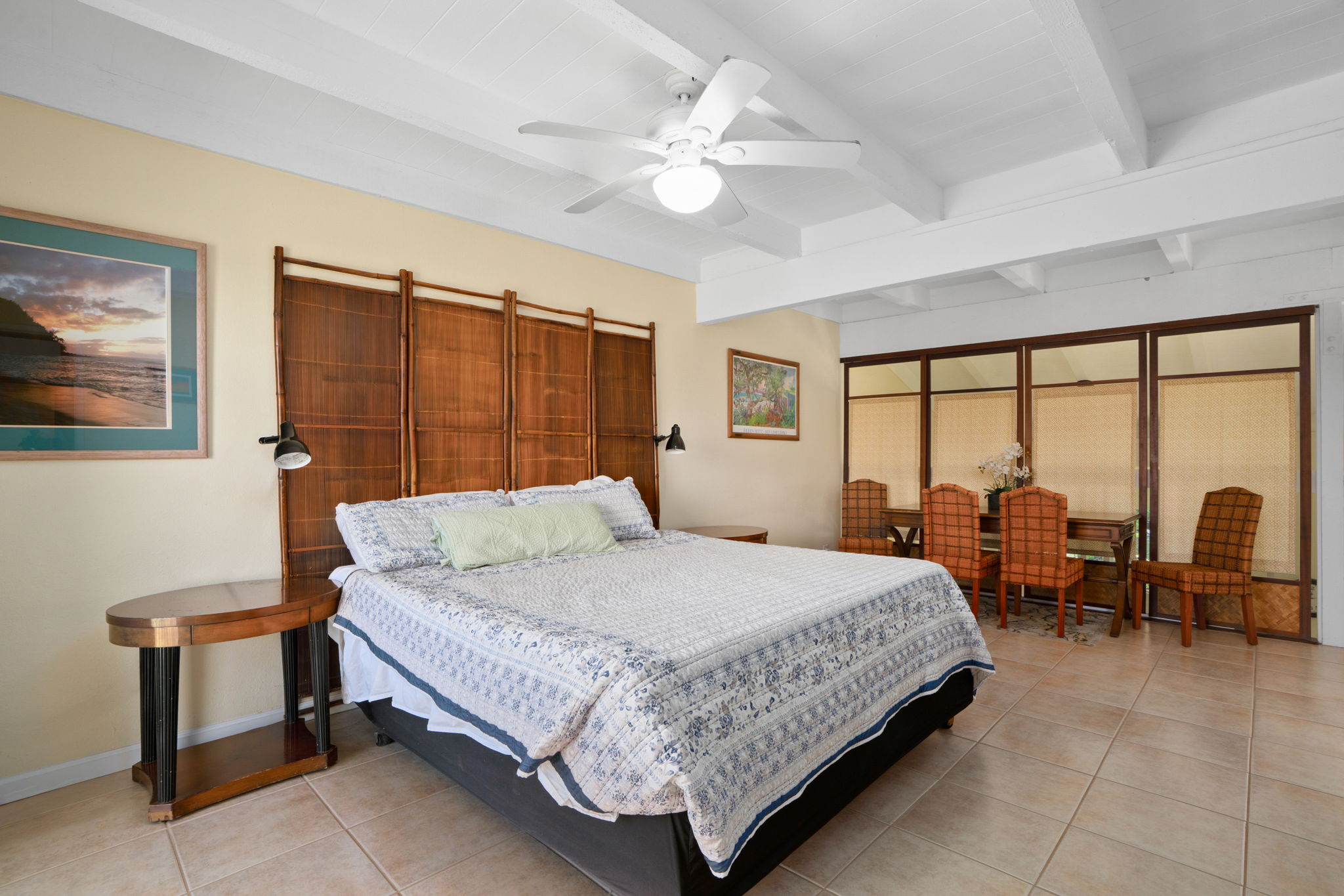 3880 Wyllie Road, Unit 20A Princeville, HI 96722 - Photo 22 of 28 a bedroom with a bed a table and a large window