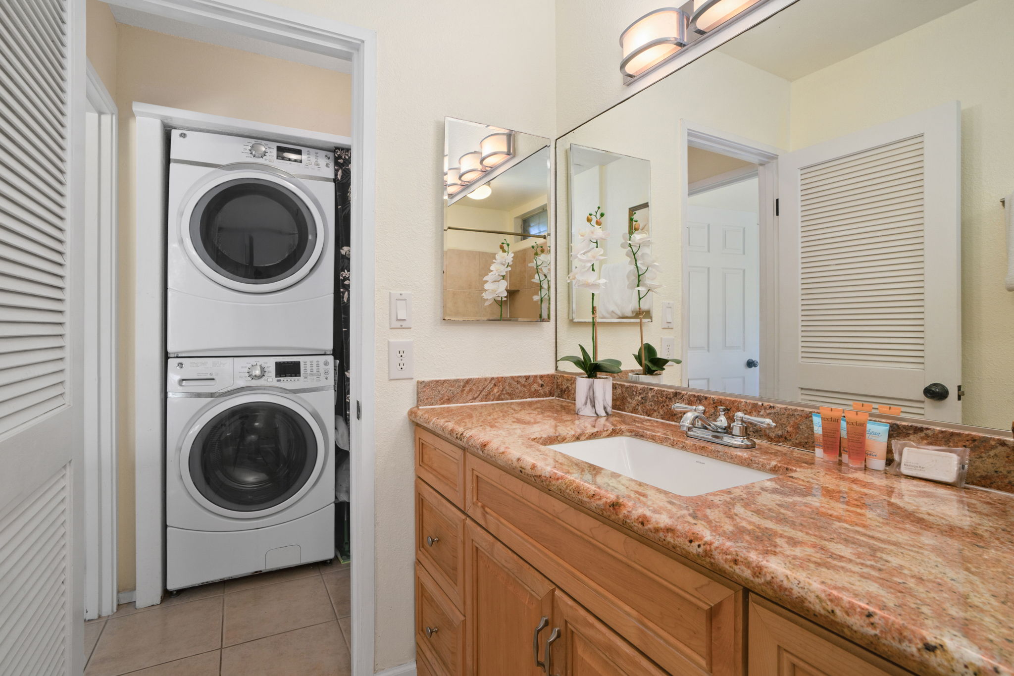 3880 Wyllie Road, Unit 20A Princeville, HI 96722 - Photo 23 of 28 a bathroom with a washing machine and a sink