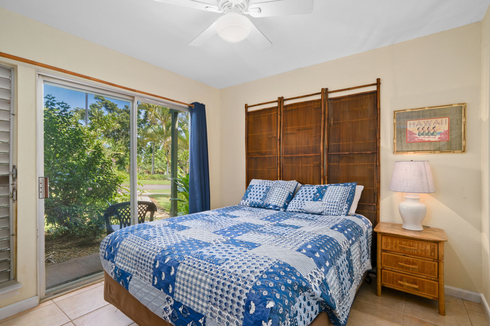 3880 Wyllie Road, Unit 20A Princeville, HI 96722 - Photo 4 of 28 a bedroom with a bed and a large window