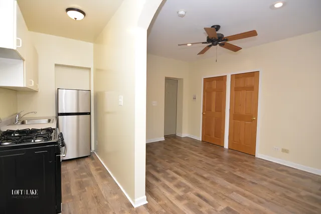 a view of a kitchen with a sink and a refrigerator