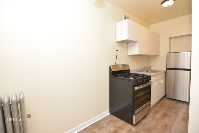 a kitchen with stainless steel appliances granite countertop a refrigerator and a stove