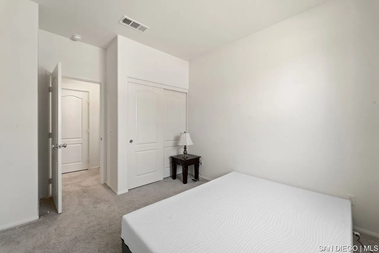 35858 Esperia Way Fallbrook, CA 92028 - Photo 17 of 37 a bedroom with a bed and a chair