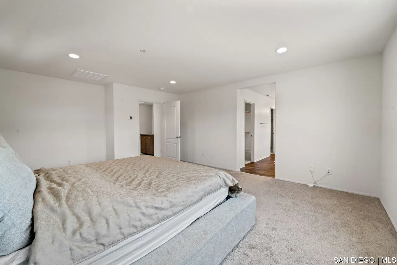 35858 Esperia Way Fallbrook, CA 92028 - Photo 20 of 37 a spacious bedroom with a bed and a cabinets