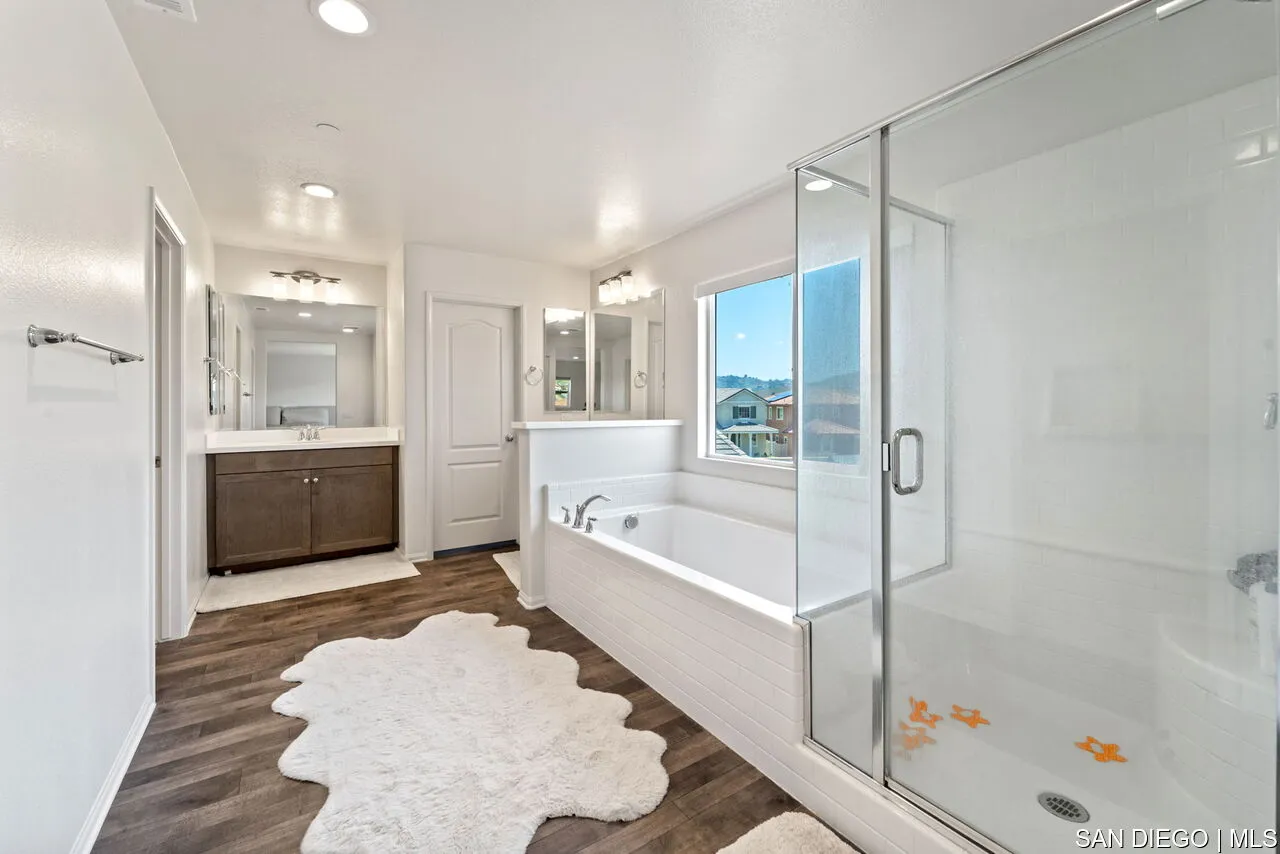 35858 Esperia Way Fallbrook, CA 92028 - Photo 21 of 37 a bathroom with a tub a sink and a shower