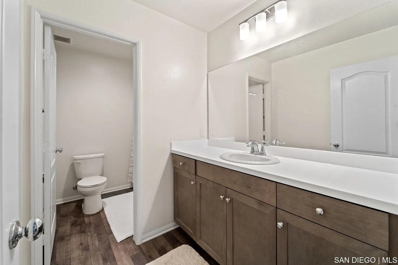 35858 Esperia Way Fallbrook, CA 92028 - Photo 27 of 37 a bathroom with a double vanity sink and a toilet
