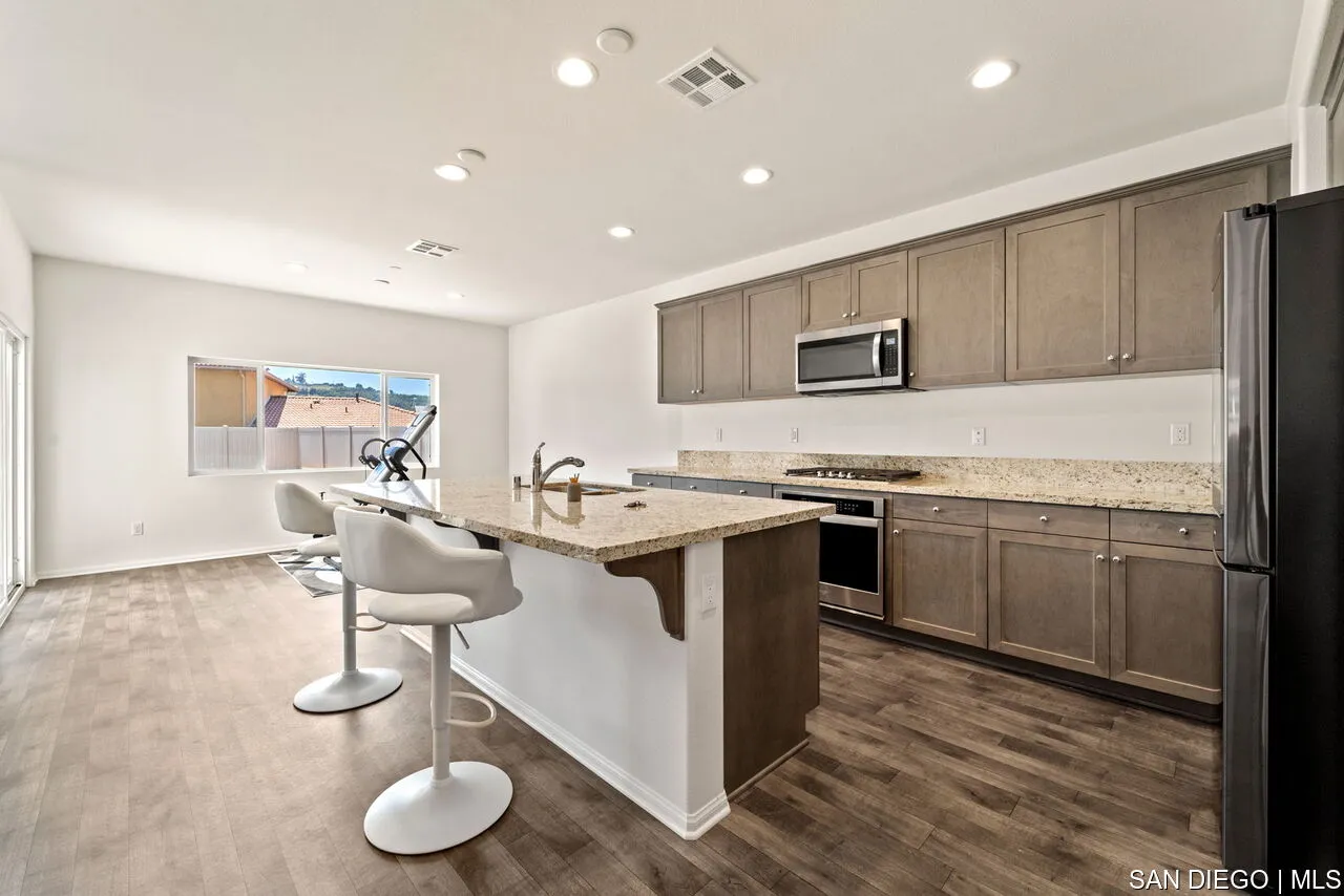 35858 Esperia Way Fallbrook, CA 92028 - Photo 4 of 37 a kitchen with a sink cabinets and wooden floor