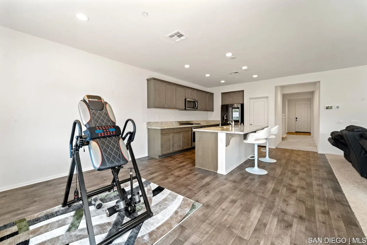 35858 Esperia Way Fallbrook, CA 92028 - Photo 5 of 37 a view of a kitchen with dining table and chairs
