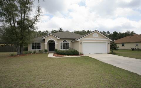 97053 Castle Ridge Drive Yulee, FL 32097 - Photo 1 of 1 a view of house with outdoor space and parking