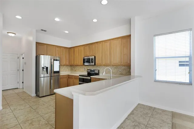 a kitchen with a refrigerator and a sink