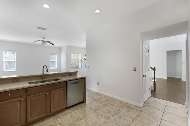 a spacious bathroom with a granite countertop sink and a mirror