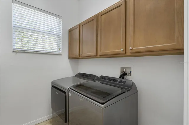 a kitchen with a sink cabinets and a microwave
