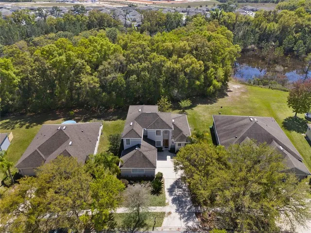 an aerial view of a house with an outdoor space