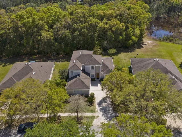 an aerial view of a house with a yard