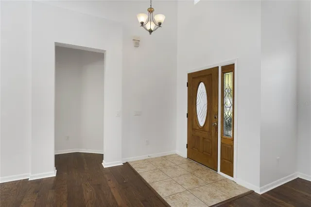 a view of a livingroom with wooden floor and a chandelier