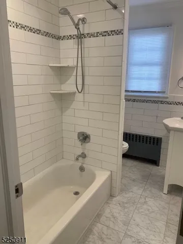 a bathroom with a bathtub and a shower