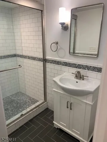 a bathroom with a sink a mirror and shower