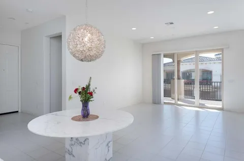 a view of a dining room with furniture wooden floor and a chandelier