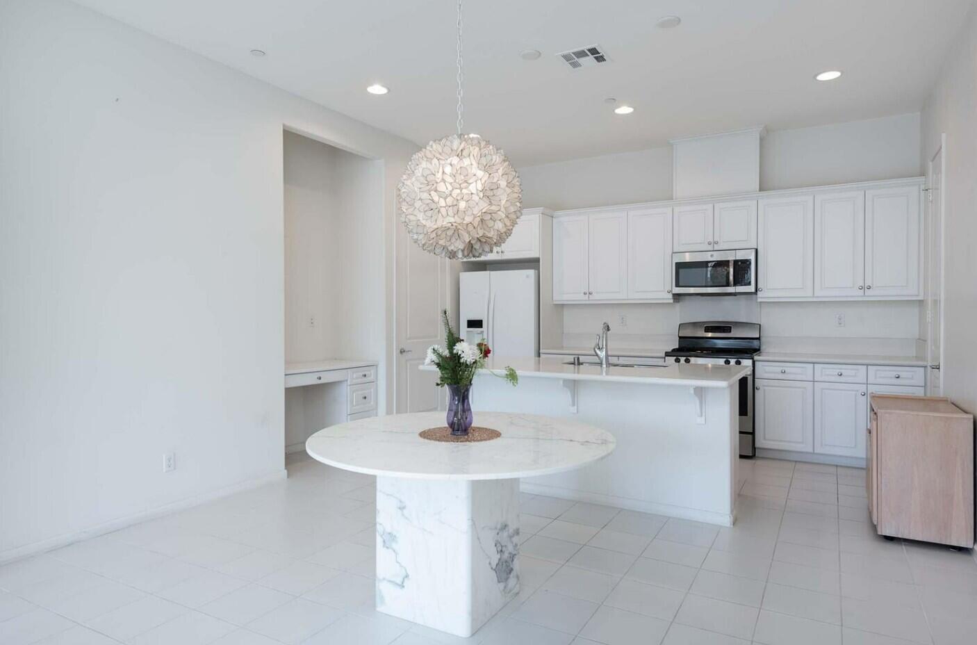 2609 Via Calderia Palm Desert, CA 92260 - Photo 5 of 10 a kitchen with kitchen island granite countertop a sink cabinets and stainless steel appliances