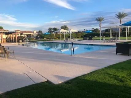 a view of a swimming pool with a yard
