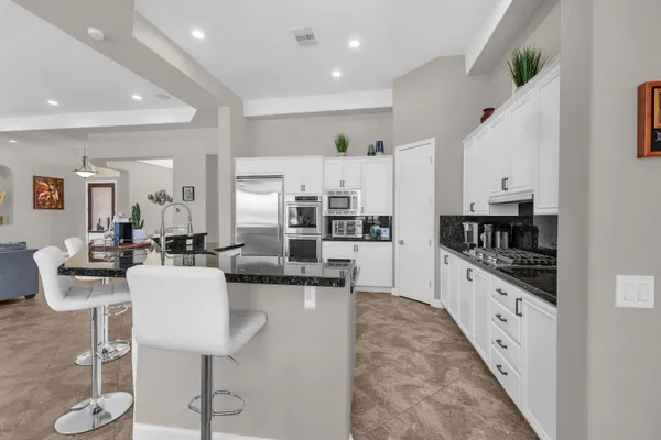 a bathroom with a sink double vanity mirror and a bathtub