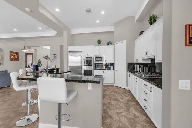 a bathroom with a sink double vanity mirror and a bathtub