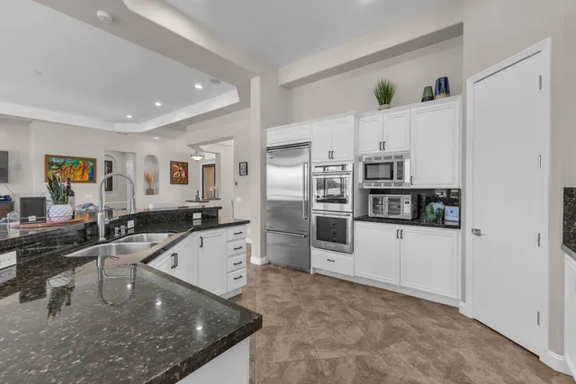 a bathroom with a granite countertop sink a mirror and a window
