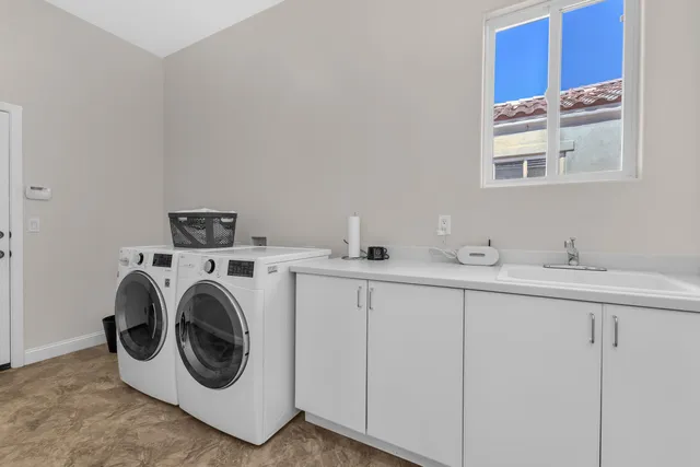 an aerial view of residential houses with outdoor space and seating