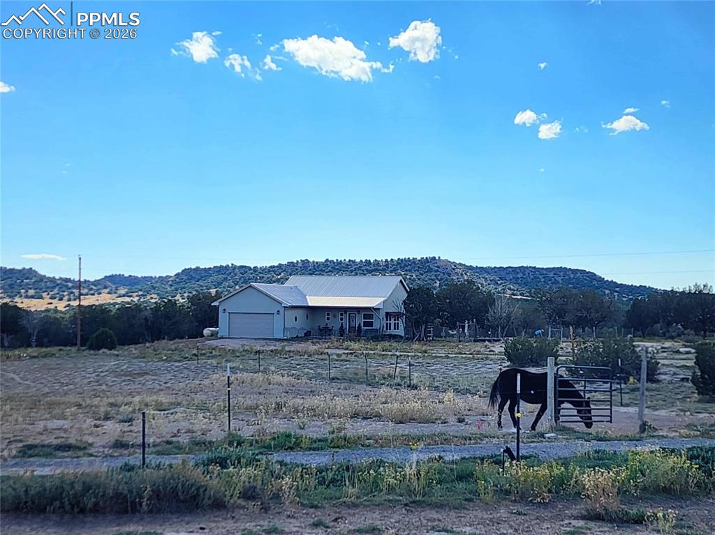 7480 Red Creek Springs Road West Pueblo, CO 81005 - Photo 1 of 47 a view of a house with a yard and a wooden fence