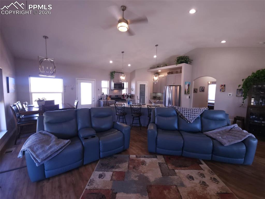 7480 Red Creek Springs Road West Pueblo, CO 81005 - Photo 12 of 47 a living room with lots of furniture and a chandelier