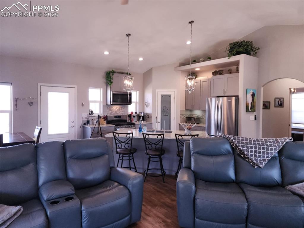 7480 Red Creek Springs Road West Pueblo, CO 81005 - Photo 13 of 47 a living room with furniture kitchen view and a wooden floor