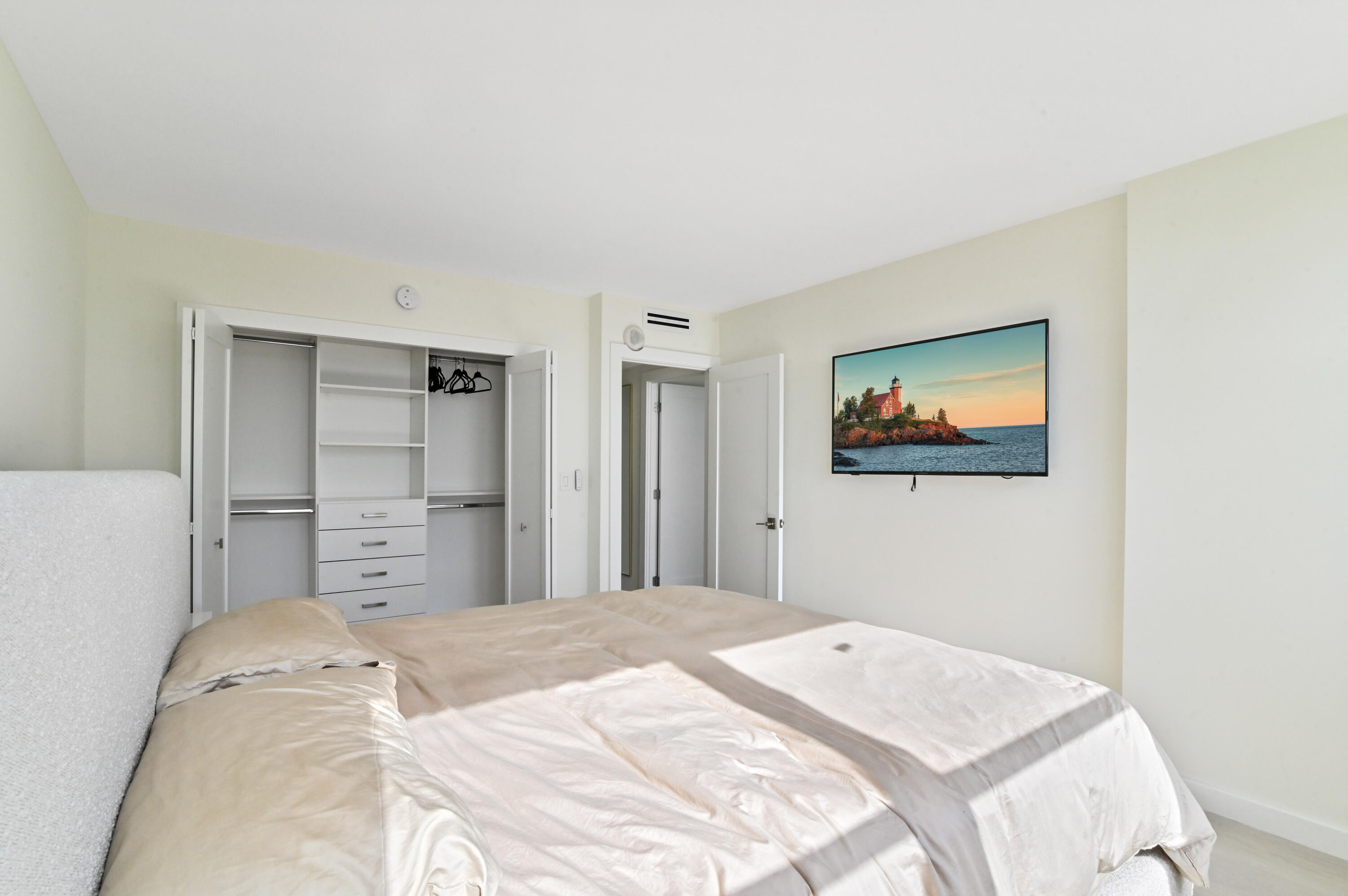 2600 North Flagler Drive, Unit 210 West Palm Beach, FL 33407 - Photo 12 of 25 a bedroom with a bed and a painting on the wall