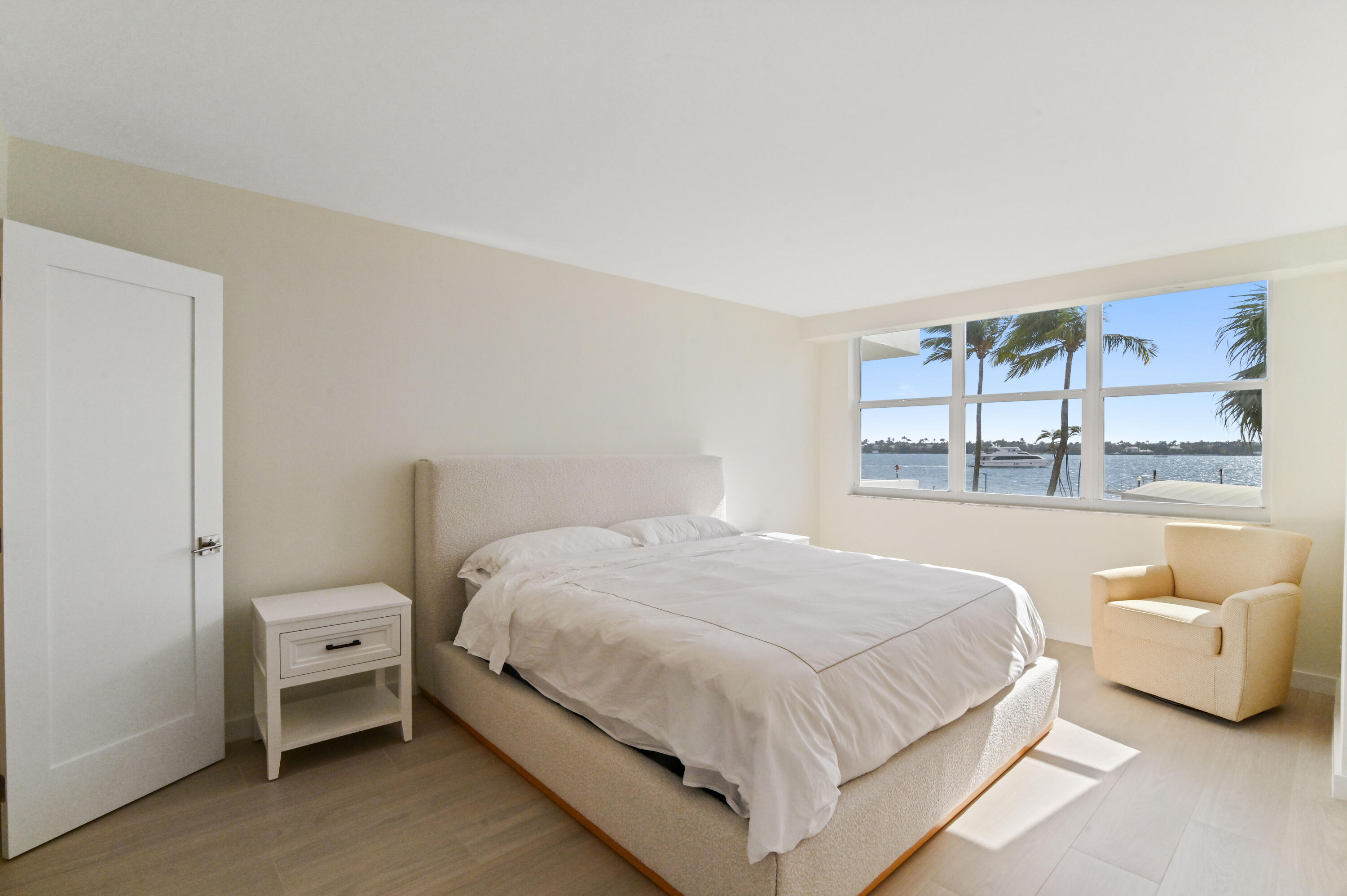 2600 North Flagler Drive, Unit 210 West Palm Beach, FL 33407 - Photo 13 of 25 a bedroom with a white bed and a large window