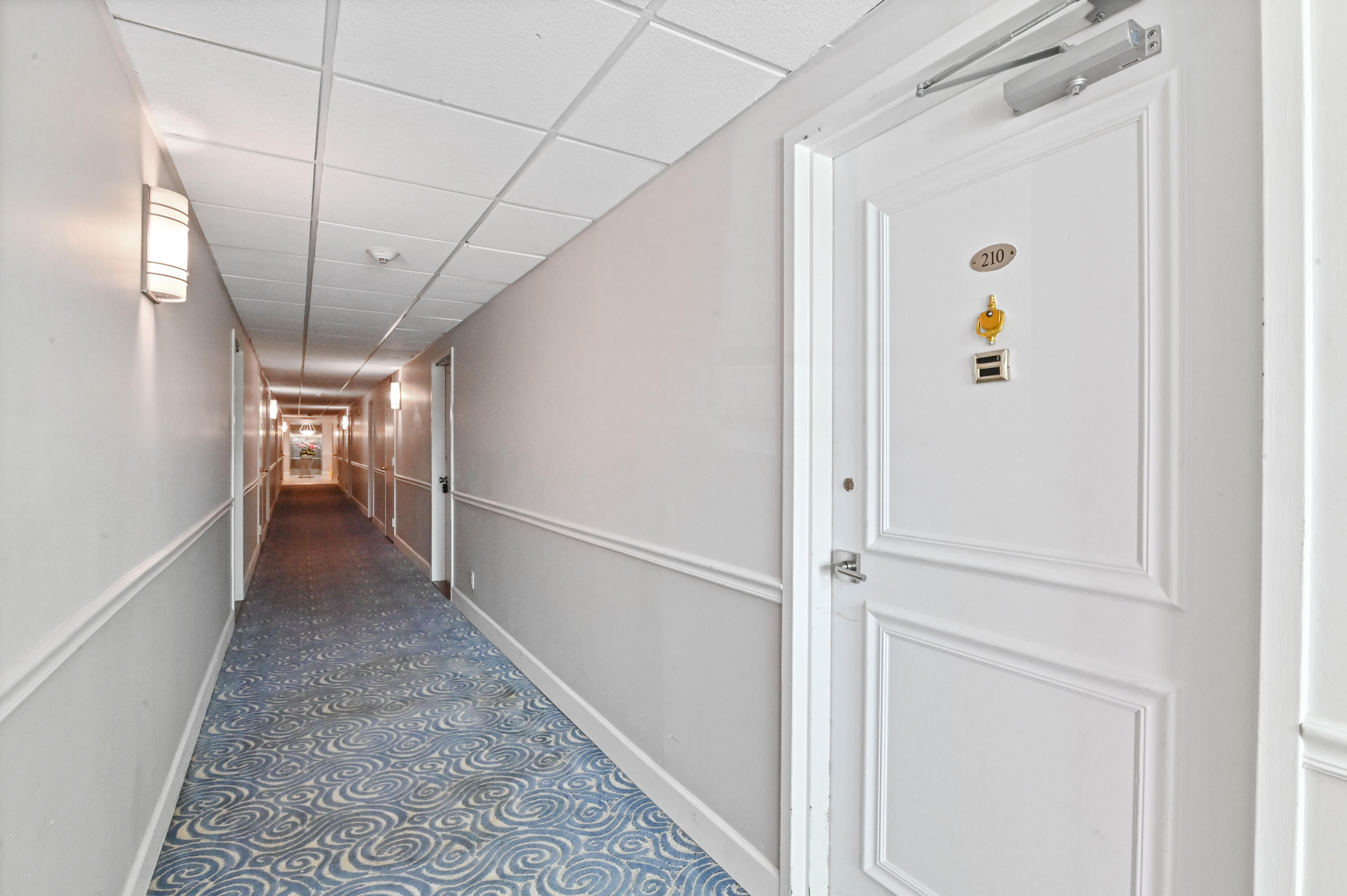 2600 North Flagler Drive, Unit 210 West Palm Beach, FL 33407 - Photo 2 of 25 a view of hallway with stairs