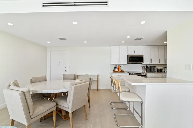 a view of kitchen with cabinets table and chairs