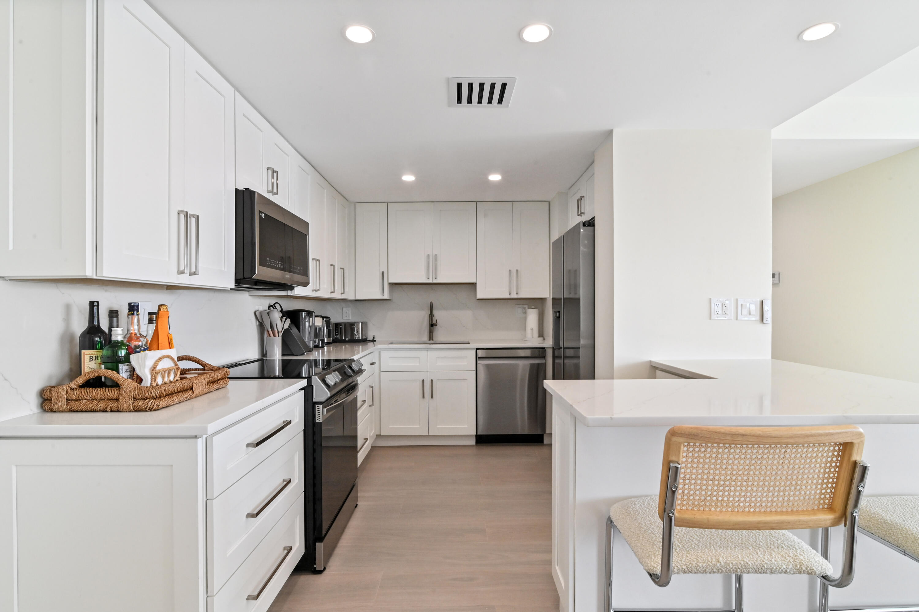 2600 North Flagler Drive, Unit 210 West Palm Beach, FL 33407 - Photo 6 of 25 a kitchen with a sink cabinets and window