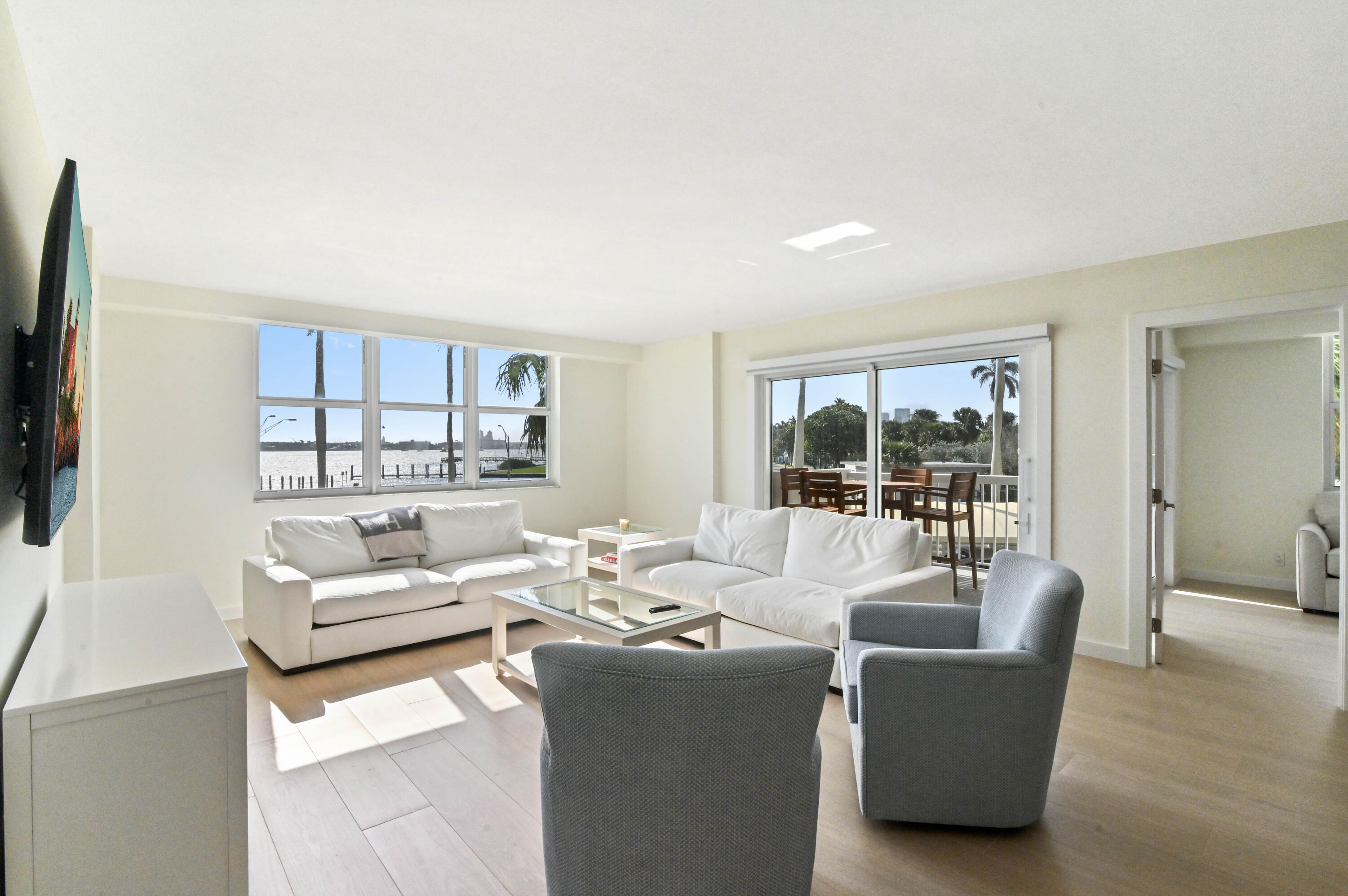 2600 North Flagler Drive, Unit 210 West Palm Beach, FL 33407 - Photo 10 of 25 a living room with furniture and a flat screen tv