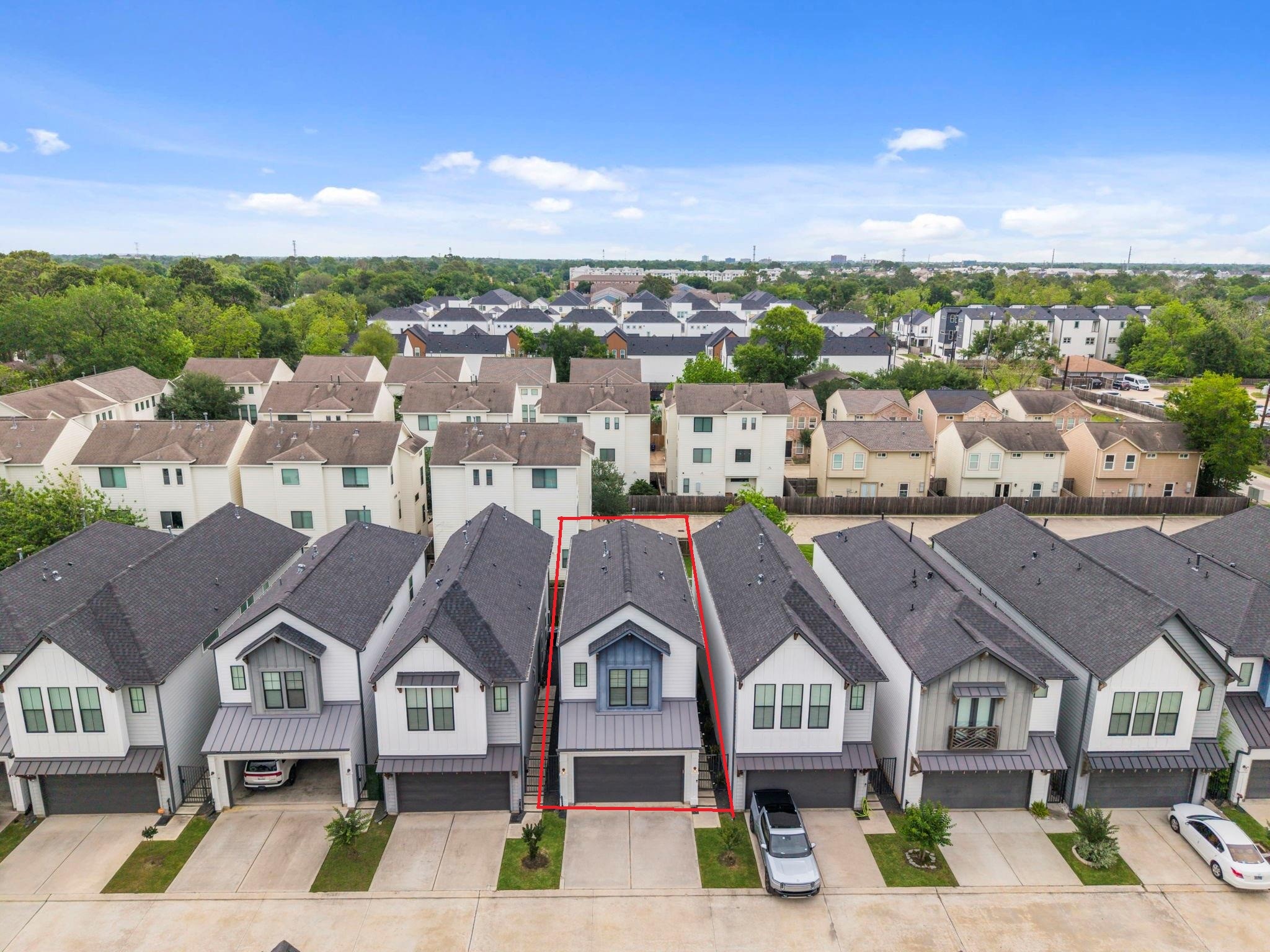 9018 Wellspring Drive Houston, TX 77080 - Photo 22 of 25 Showcasing the clean lines and uniform architecture of this exclusive enclave, this angle highlights the property's prime position within a meticulously maintained row of contemporary freestanding homes.