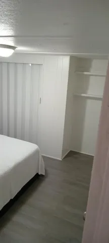 a bed room with a bed and a window