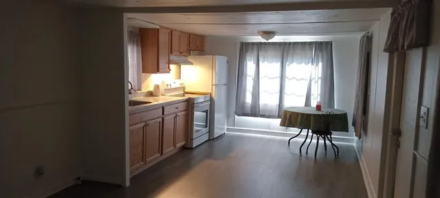 a view of a hallway with furniture and a window