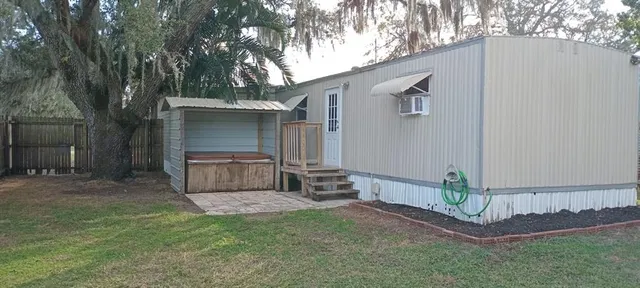 a backyard of a house with oven and a tree