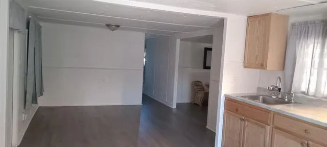 a kitchen with a refrigerator and a sink