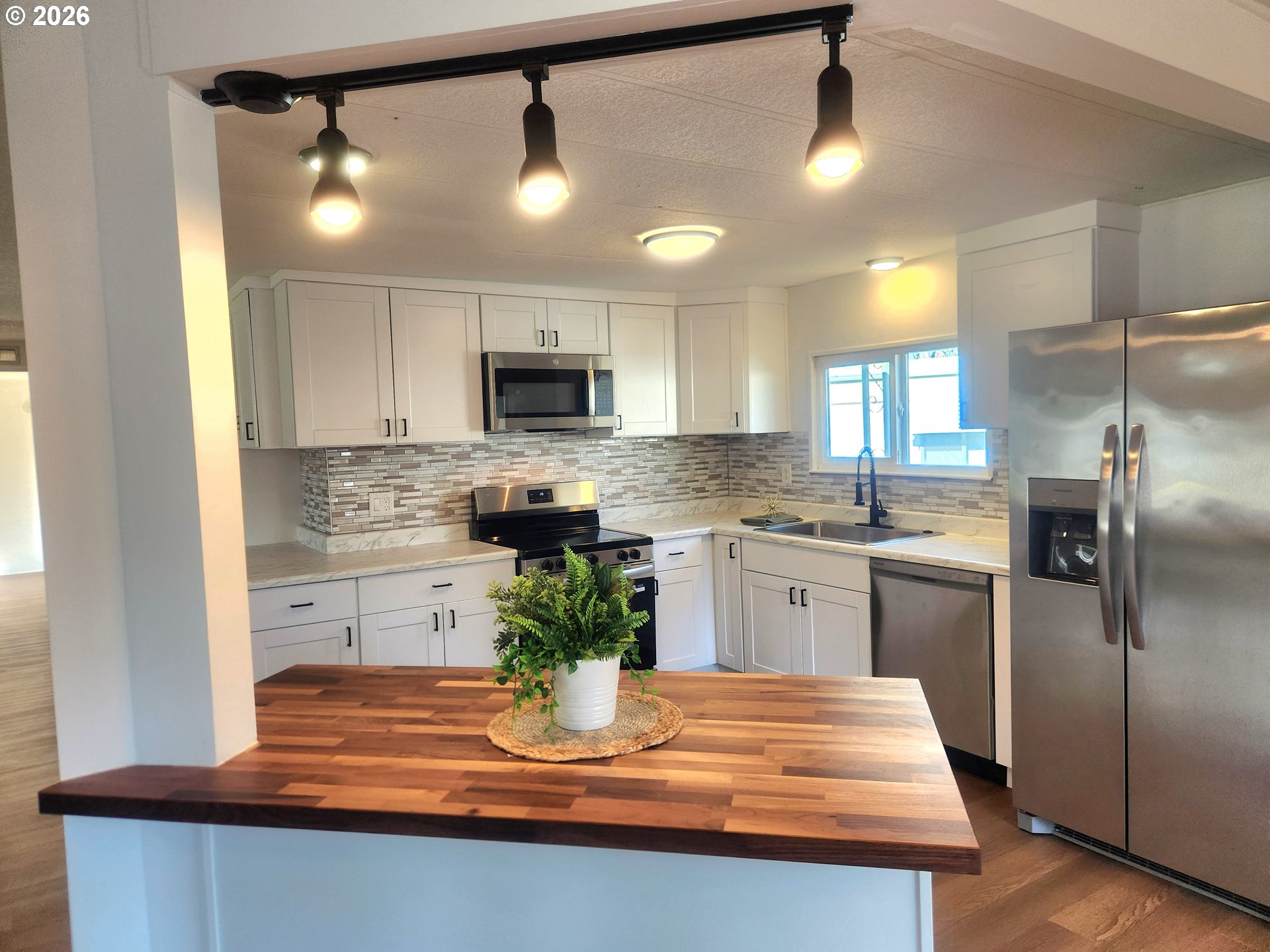 507 North 19th Avenue, Unit 29 Cornelius, OR 97113 - Photo 13 of 26 a kitchen with kitchen island granite countertop a sink stainless steel appliances and cabinets